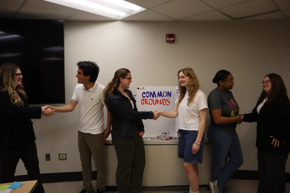 Students in the Common Grounds club shake hands