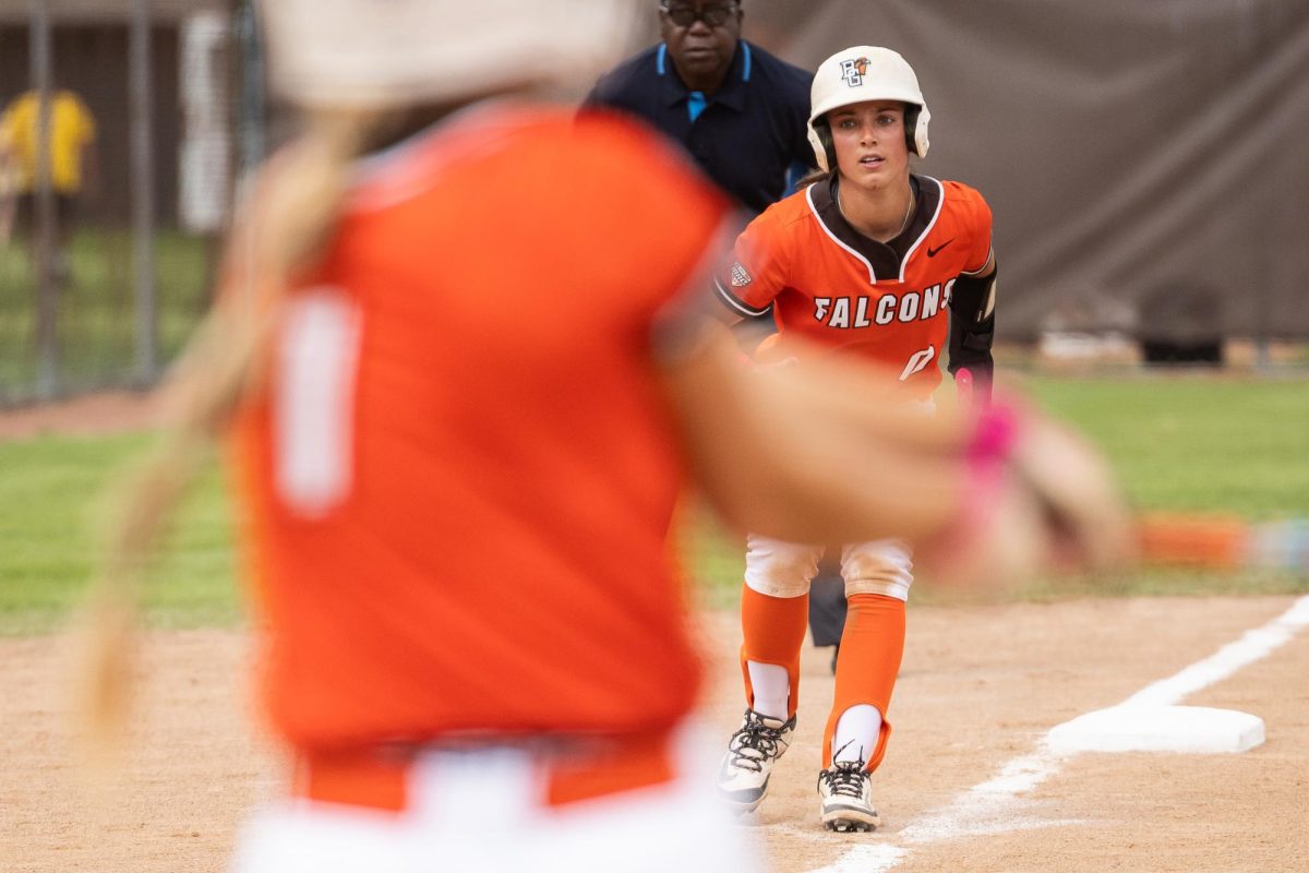Bowling Green, OH - Falcons redshirt sophomore third baseman  Addie Martin (0) leads off third base while Falcons freshman outfielder Hannah Simko (1) swings during a game between the Massachusetts Minutewomen and the Bowling Green Falcons at Meserve Field in Bowling Green, Ohio. 