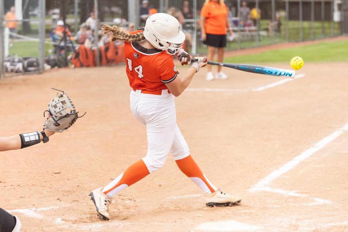 Bowling Green, OH - Falcons senior catcher Ashley Chevalier (14) drives the ball to the outfield during a game between the Massachusetts Minutewomen and the Bowling Green Falcons at Meserve Field in Bowling Green, Ohio. 