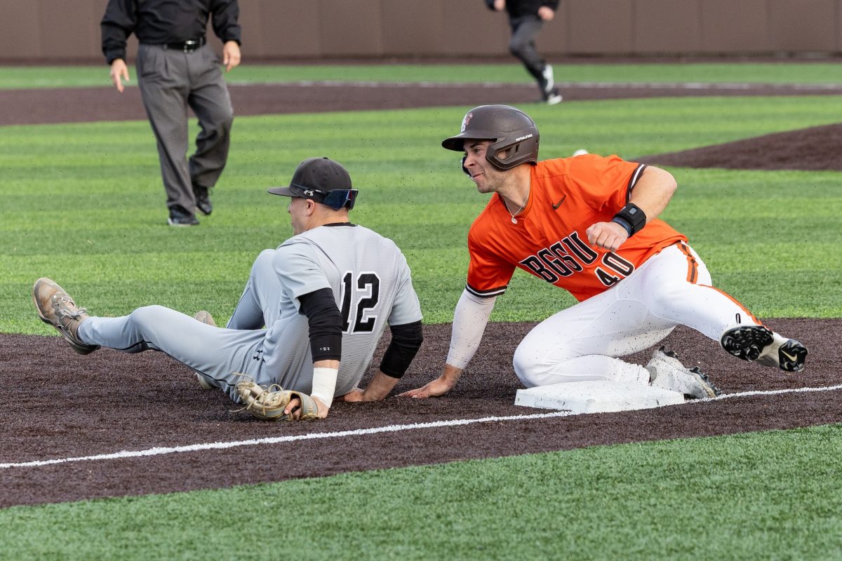 Bowling Green, OH - Falcons redshirt senior infielder Anthony Mitta (40) looks at the throw in the outfield after getting twisted with Gray Wolves senior infielder A.J. Brinson (12) at Steller Field, in Bowling Green, Ohio.