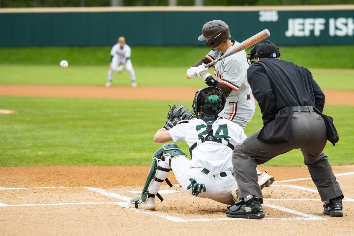 East Lansing, MI - Falcons senior infielder Sam Seidel (21) begins his swing during a game between the Bowling Green Falcons and the Michigan State Spartans at Jeff Ishbia Field at McLane Stadium in East Lansing, Michigan.